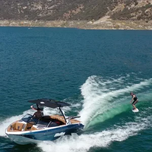 Modern speedboat enjoying smooth ride along a picturesque coastline.